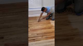 Hand scraping a hardwood floor