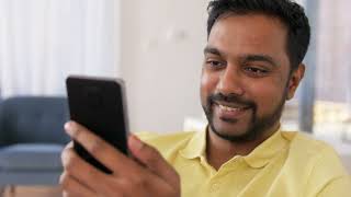 Happy Indian Man with Smartphone at Home free stock video for everyone