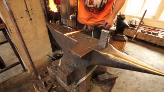 Artist blacksmith Tobbe Malm forging a corkscrew