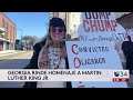 manifestantes protestan contra trump en atlanta durante marcha por el día de martin luther king jr.