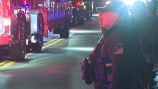 Officers line procession for dignified transfer of National Guard Member killed in shooting