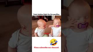 Twin baby girls fight for pacifier.