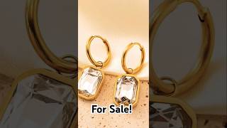 Suits only on you! Gold-toned rectangular hoop earrings featuring gemstones for an elegant look.