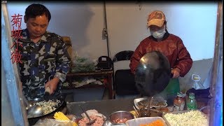 Next to the couple's university apartment, there is a stall selling fried rice noodles