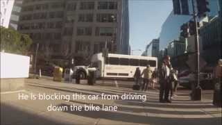 Bicyclist blocks driver from driving down bike lane