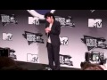 Lady Gaga dressed as a man talks to reporters backstage at MTV Video Music Awards 2011