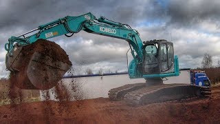 Kobelco and Hitachi Excavators Loading Trucks