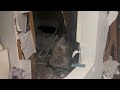 caught on camera a boulder crashes into a home nearly hitting a woman