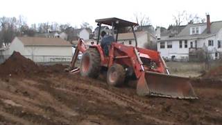 Kubota L48 backhoe digging foundation