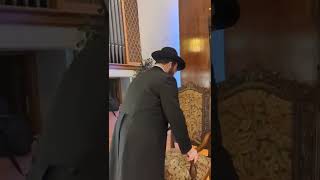 A Mohel performs a Jewish circumcision... Rabbi Heber is looking up to make sure lighting is good