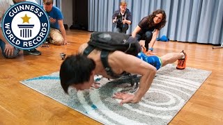 Most push ups on the back of the hands carrying a 40 lb pack in one minute - Guinness World Records