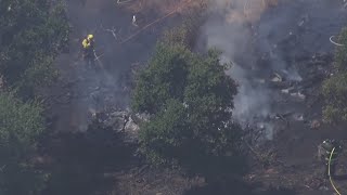 Evacuations lifted in Napa after brush fire burns near homes.