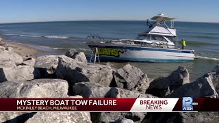 Workers try for hours to salvage boat stuck on Milwaukee's shore