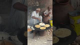 80 years old man selling parathas in roadside.