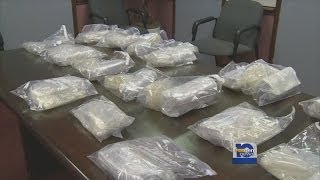 Heroin, cocaine, cash, car confiscated