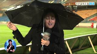 crazy wind blew the reporter umbrella. funny