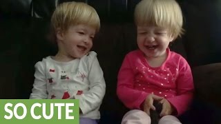 Identical twin babies find kisses hilariously entertaining