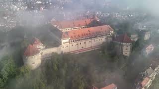 Circling around the historic castle of Hohentübingen in the city of Tübingen in the morning fog