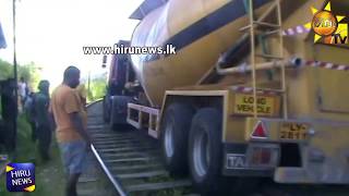 A container truck tops over to a railway