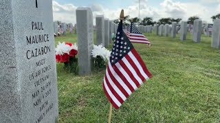 Volunteers place flags at Veterans Cemetery ahead of Memorial Day