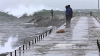 Watch surfers brave large waves and snow in Muskegon