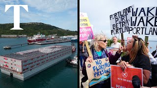 Protesters clash as migrant barge docks in Portland