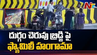 దుర్గంచెరువు బ్రిడ్జిపై ఓ ఫ్యామిలీ హంగామా | Family Stop Vehicles on Durgam Cheruvu Bridge | Ntv