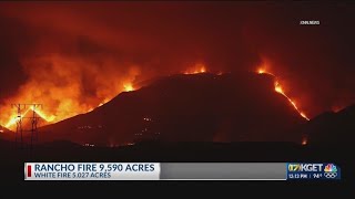 Rancho fire evacuation order reduced to a warning, White fire rages on