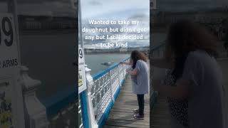 Hand feeding a seagull at Llandudno pier