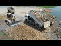 perfect action smart operator dozer clean rock into water with team work dump trucks unloading