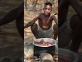 A Hadza hunter skillfully cooks in the forest, blending survival with tradition