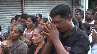 People hold a vigil outside St. Anthony's Shrine