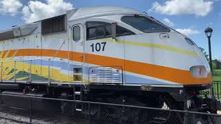 Sun Rail 107 with a maintenance truck on opposite track