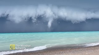 Funnel stretches down from storm clouds over Lake Huron