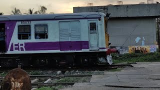 Local train passing through rail gate on a rainy afternoon sealdah ranaghat local