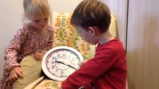 Young boy learning to tell the time using EasyRead Time Teacher Clock