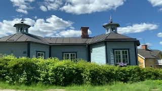 Driving in Sweden: country side and small town houses, window view while driving to Flen