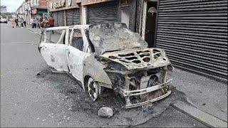 Burnt-out cars and smashed shops as violence flares during Middlesbrough riot | AFP