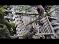 Building a bushcraft log cabin with a fireplace in the wild forest. Winter camping