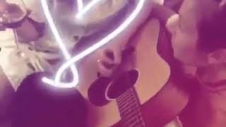 Dominique provost-chalkley singing and playing guitar