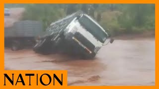 A lorry crossing the flooded Gituma River in Tharaka gets stuck halfway.
