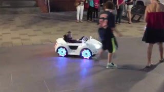 Kid riding around Discovery Green in a remote control power wheel