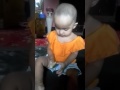 Cute baby eating lemon first time.