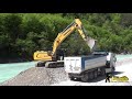 liebherr 936 excavator digging and loading gravel on volvo trucks