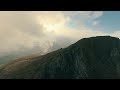 extreme mountaineering with drones. flying around in the clouds