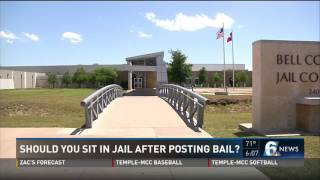 Should you sit in jail after posting bail?
