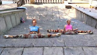 Training splits on the street. Two flexible girls. Contortionist Alesya and ballerina Rimma.