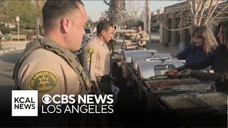 Volunteers prepare hot meals for deputies from LA County's Altadena Sheriff station