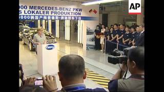 WRAP German chancellor visits Benz factory, company sot on sales