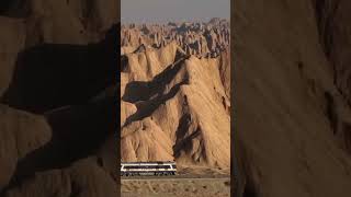 A train passes through the red stone forest in Kuqa, Xinjiang火车🚞从新疆库车红石林驶过